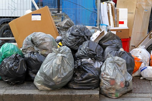 Licensed waste carriers handling a junk removal job in line with regulations