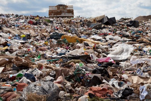 Waste removal crew loading mixed rubbish for disposal in London